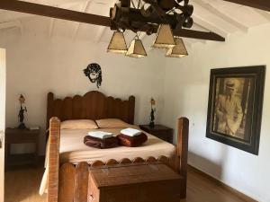 a bedroom with a bed and a picture on the wall at La Kolorina hotel campestre in Jericó