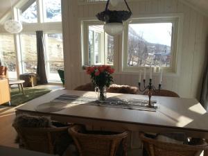a dining room with a table and some windows at Moderne feriehus in Laupstad +40 photos