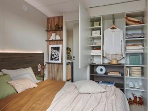 a bedroom with a bed and a book shelf at Camping de La Hallerais Dinan in Taden +57 photos