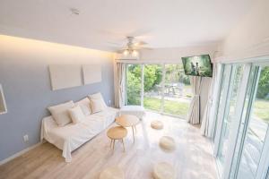 a living room with a white couch and a table at Third Place Onna Tancha Villa in Onna