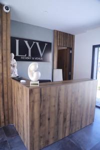 a reception desk in an office with a sign at Lyv Resort and Venue in Şannīn +86 photos