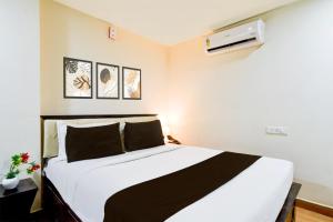 a bedroom with a bed and a air conditioner at Townhouse Gachibowli Near Gopichand Academy in Hyderabad
