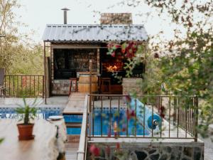 a small house with a fireplace in a yard at Cascata Lodge in Outjo