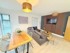 a living room with a couch and a table at Orchard Point in Southampton