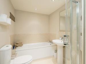a bathroom with a tub and a toilet and a sink at Hurworth - 25565 in Knapton