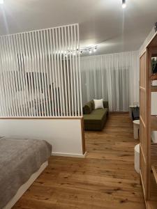 a bedroom with a bed and a couch in a room at Moderne Apartments in Wicker in Flörsheim am Main