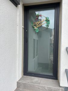 a black door with a christmas wreath on it at Moderne Apartments in Wicker in Flörsheim am Main +6 photos