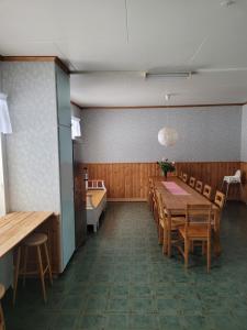a dining room with a long table and chairs at Tyforsgården in Mjölnartorpet +16 photos