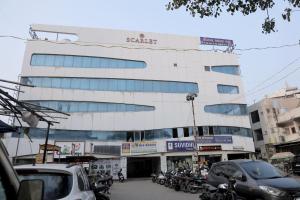 a building with motorcycles parked in front of it at Hotel Sky Blue in Surat