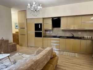 a living room with a couch and a kitchen at Ardbay Apartment in Golem