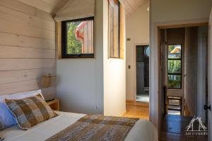 a bedroom with a bed and a window at Casas Arco Jardin in Castro
