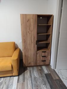 a living room with a couch and a cupboard at Altea - Lago di Como nuovo accogliente mini appartamento vicino alla spiaggia e giardino in Dervio