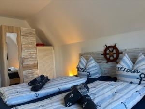 a bedroom with two beds and a wooden head board at Ferienhaus Edda in Timmendorfer Strand