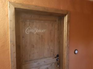 a wooden door with the words carolina lender written on it at Gohrischer Hof Anno 1798 in Kurort Gohrisch
