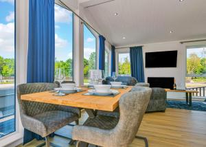 a dining room with a wooden table and chairs at Finest Retreats - Silverwood Junior Chalet in Errol