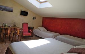 a bedroom with a bed and a table and a couch at Des Lits Sur La Place in Hérépian