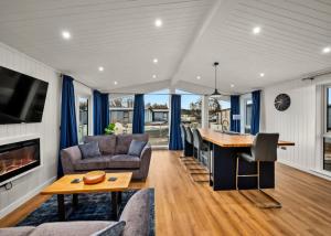 a kitchen and living room with a table and chairs at Finest Retreats - Silverwood Premium Chalet in Errol