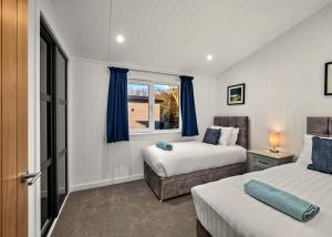 a bedroom with two beds and a window at Finest Retreats - Silverwood Premium Chalet in Errol