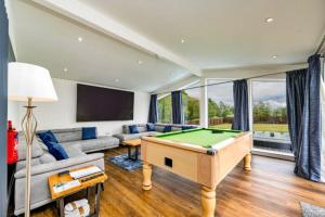 a living room with a pool table at Finest Retreats - Silverwood Executive Chalet in Errol +6 photos