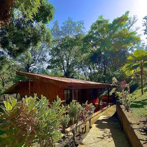 a small house in the middle of a garden at Cabañas Luz de Luna in Llano Grande