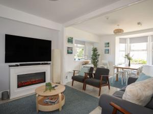a living room with a fireplace and a tv at Angorfa Apartment in Pwllheli