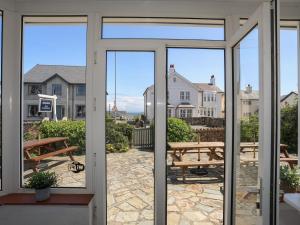 a sliding glass door with a view of a patio at Angorfa Apartment in Pwllheli