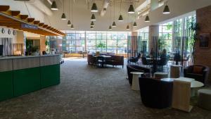 a lobby of a restaurant with tables and chairs at Prince Conference Center & Hotel in Grand Rapids