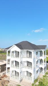 an aerial view of a white apartment building at Upole HOTEL in Nungwi