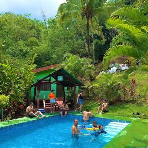 a group of people in a swimming pool at Cabañas Luz de Luna in Llano Grande