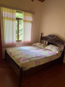 a bedroom with a bed in a room with windows at Cabañas Luz de Luna in Llano Grande +84 photos