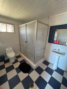 a bathroom with a shower and a toilet and a sink at Casa Mirador Pichilemu in Pichilemu +28 photos