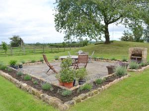 a patio with a table and chairs and plants at Hurworth - 25565 in Knapton