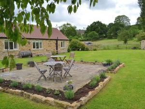 a patio with a table and chairs in a yard at Hurworth - 25565 in Knapton +4 photos