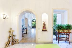 an archway in a living room with a table and chairs at Villa Lalen Sorrento Private Luxury Residence with Garden, Terrace & Jacuzzi in Sorrento