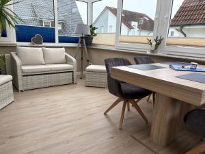 an office with a table and chairs and windows at Ferienhaus Edda in Timmendorfer Strand +17 photos