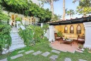 a house with a garden with a patio at Villa Lalen Sorrento Private Luxury Residence with Garden, Terrace & Jacuzzi in Sorrento