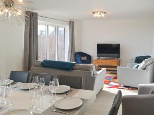 a living room with a table and a couch at Ad Gefrin in Acklington