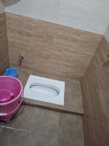 a bathroom with a white toilet in the floor at Vamika Palace in Ayodhya