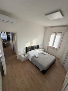 a white bedroom with a bed and a window at Santa Rita Home in Novara