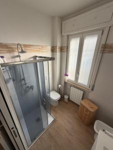 a bathroom with a shower and a sink and a toilet at Santa Rita Home in Novara +13 photos