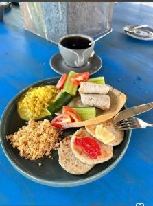 a plate of food with rice and vegetables and a cup of coffee at Happy Laugh Ella in Ella