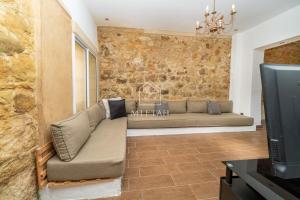 a living room with a couch and a tv at Charming villa with pool and unobstructed view in Tangier
