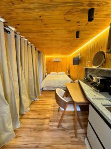 a bedroom with a bed in a wooden ceiling at NATU Visconde de Mauá in Itatiaia +22 photos
