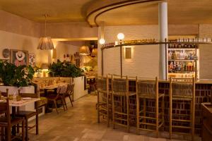 a restaurant with tables and chairs and a bar at The Hoxton, Dublin in Dublin