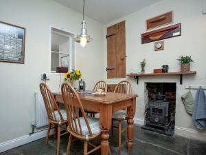 a dining room with a table and chairs and a fireplace at Tillerman Cottage Appledore Devon in Appledore +20 photos