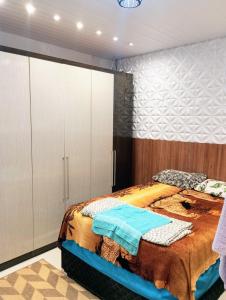 a bedroom with a bed and white cabinets at Riviera engenharia in Campo Grande +15 photos