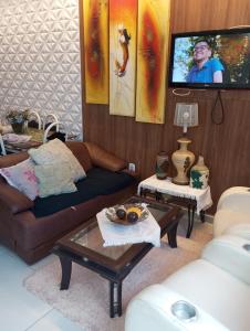 a living room with a couch and a tv at Riviera engenharia in Campo Grande