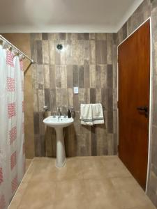 a bathroom with a sink and a shower at La Esquina en el Rio in Paraná +6 photos