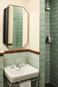 a bathroom with a sink and a mirror at The Hoxton, Dublin in Dublin +27 photos