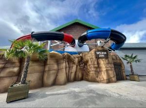 a water park with two slides on a wall at 8 berth 3 Bedroomed CARAVAN Lyons Robin Hood Rhyl 17 Elm Crescent in Meliden